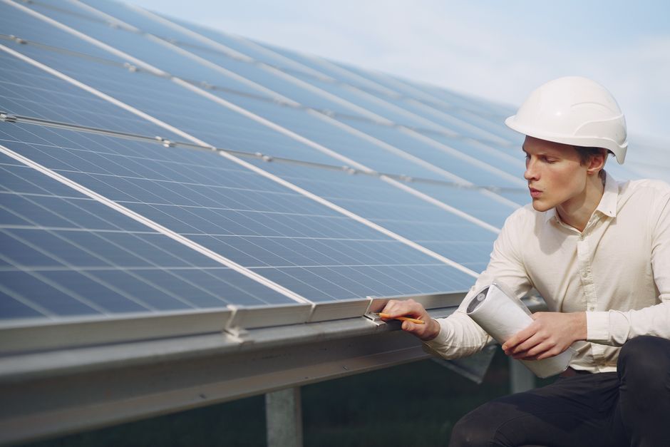 Solar installation worker inspecting a rooftop array